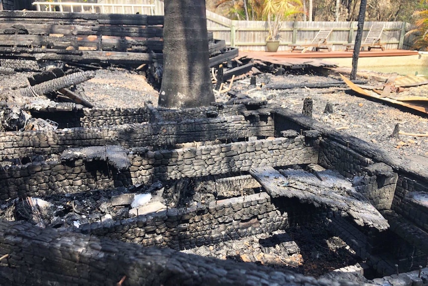 Charred remains of the back deck at the bushfire-destroyed home of Holly and David Kemp.