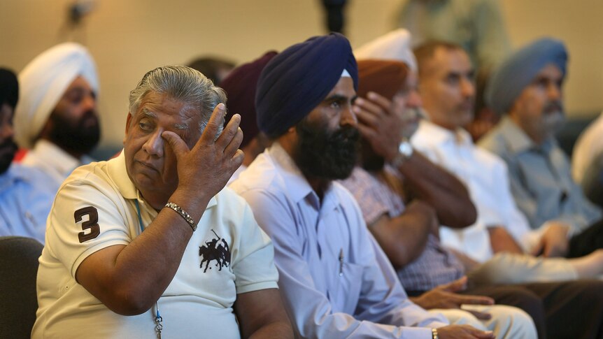 Sikh community members weeps after the temple shooting