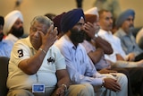 Sikh community members weeps after the temple shooting