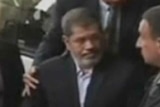 Morsi arrives for trial in Cairo November 4 2013.