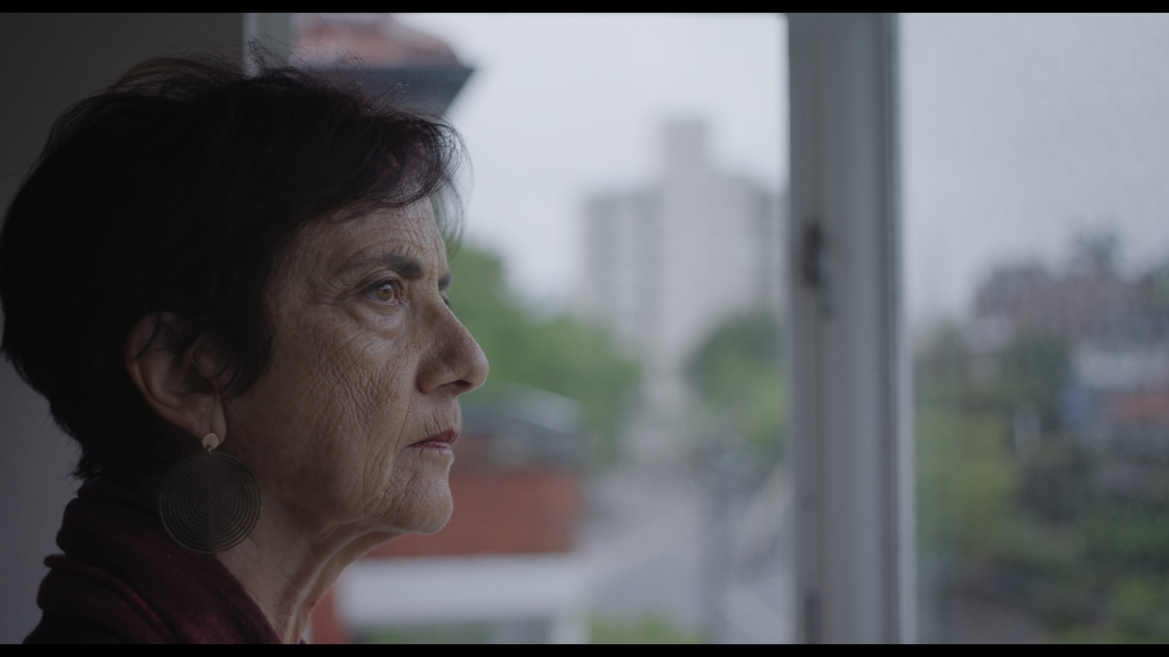 Vittoria Pasquini looks out a window in profile