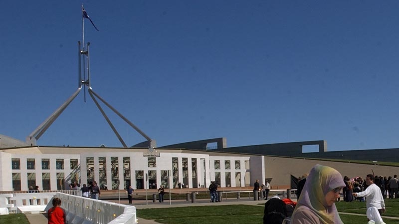 Woman stands outside Parliament House, Canberra.