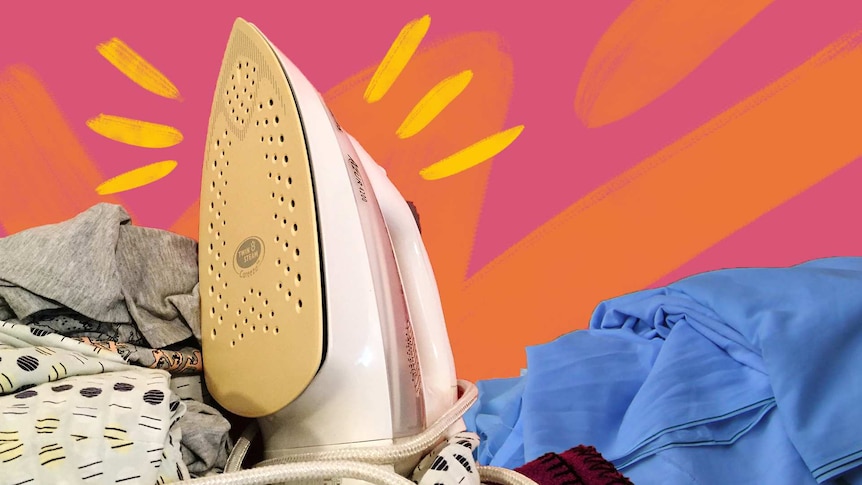 Iron surrounded by wrinkled clothes and bed linen on a pink and orange background