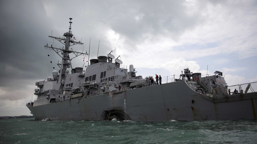 The Navy guided-missile destroyer USS John McCain is seen in choppy waters after a collision. 