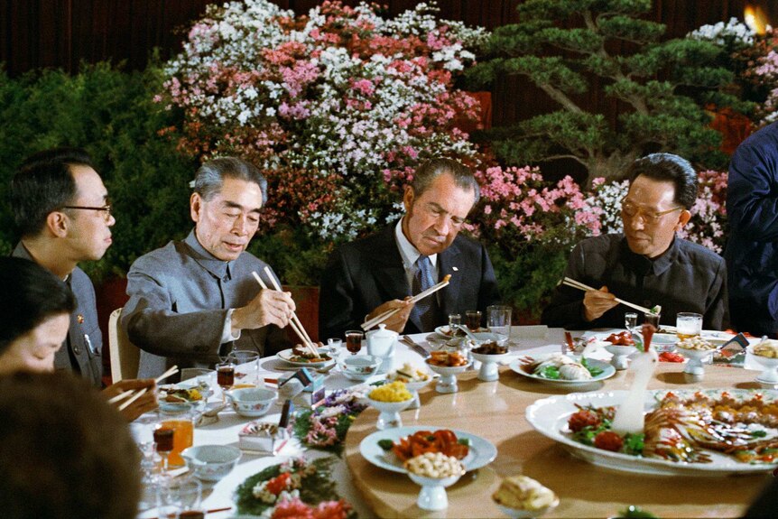 Richard Nixon uses chopsticks during a Chinese banquet with Chinese premier Chou En-lai.