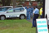 Forensic police leave a park where a baby's body was found at Kingston, Tasmania.