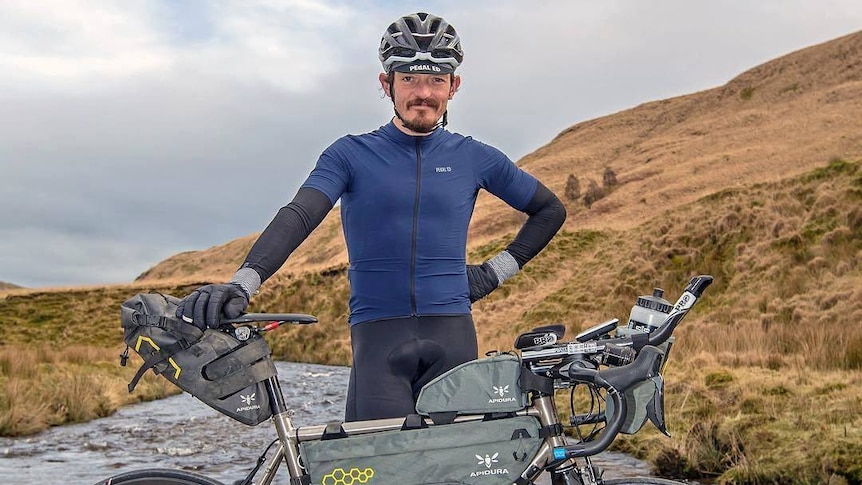 Mike Hall poses with a mountain bike.