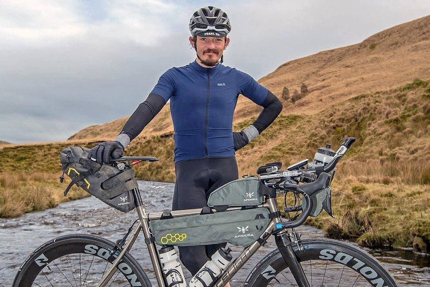 Mike Hall poses with a mountain bike.