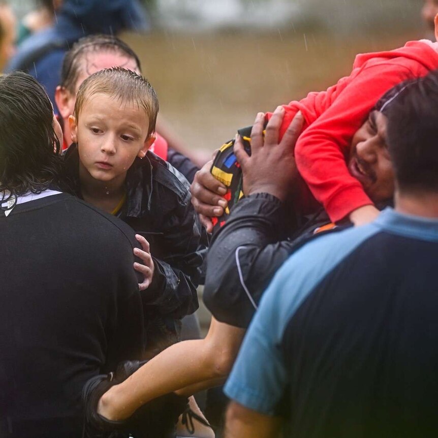 A group of people, including two children, during the Lismore flood rescue.