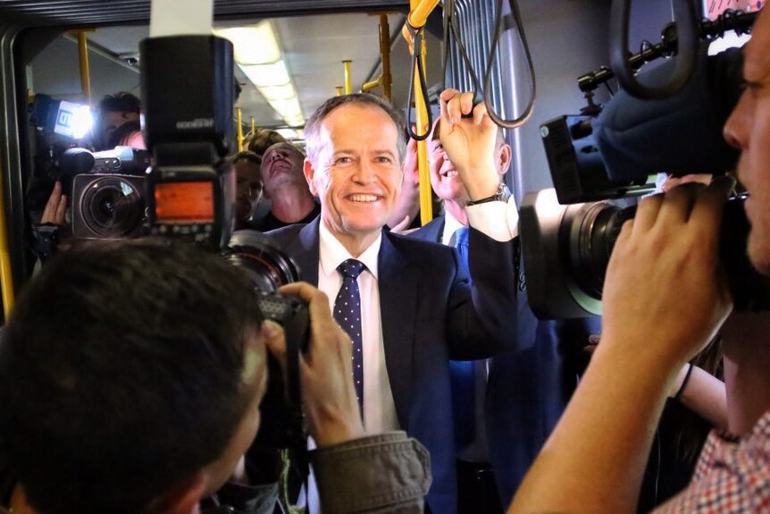 Bill Shorten smiles as he rides in an Adelaide tram