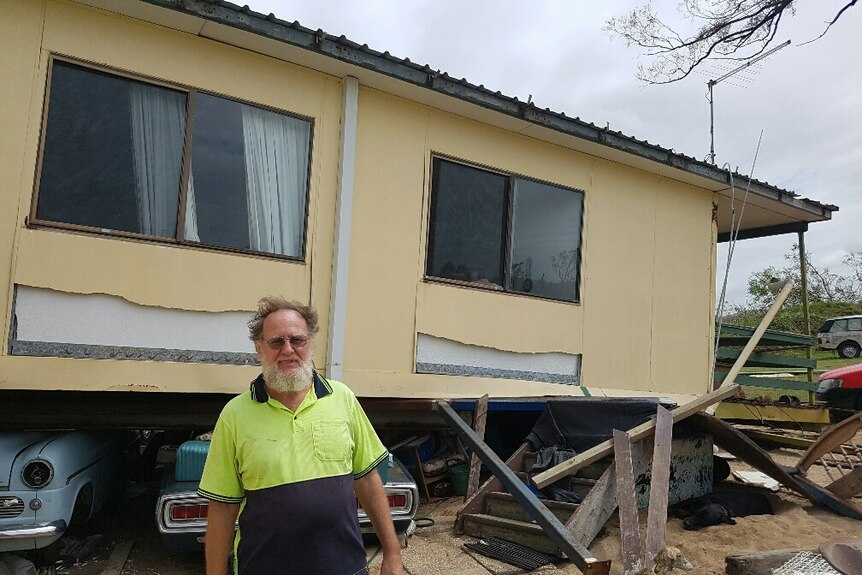 Ivan Warden in front of his house, which was uprooted during Tropical Cyclone Debbie
