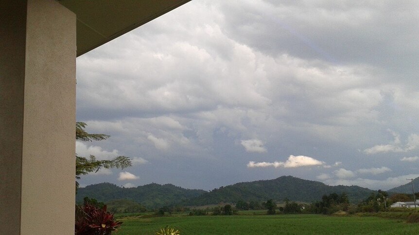 view of rolling hills and dark clouds from veranda of the house where Sol Daley was struck by lightning