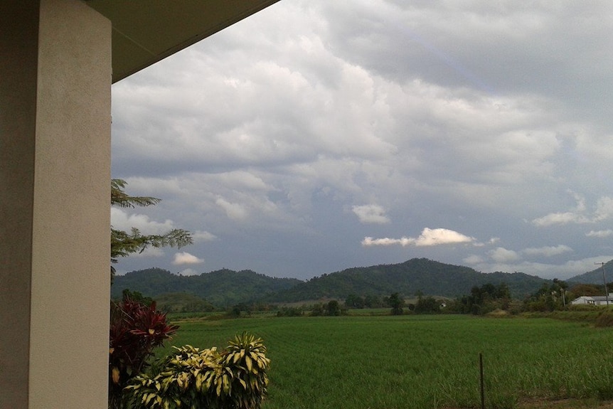 view of rolling hills and dark clouds from veranda of the house where Sol Daley was struck by lightning