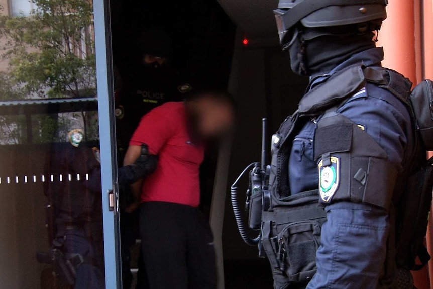 A man is arrested in Merrylands by AFP officers.