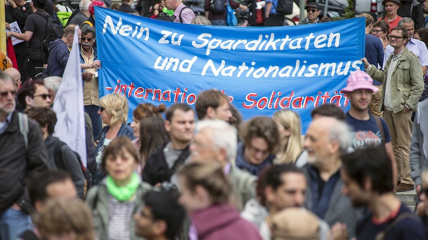 Activists attend a demonstration on World Refugee Day in Berlin