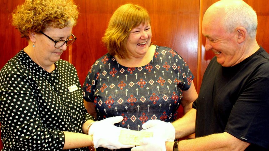 NLA Curator of Manuscripts Kylie Scroope (left) accepting the 1824 letter from Claire Henson and Keith Blackburn.