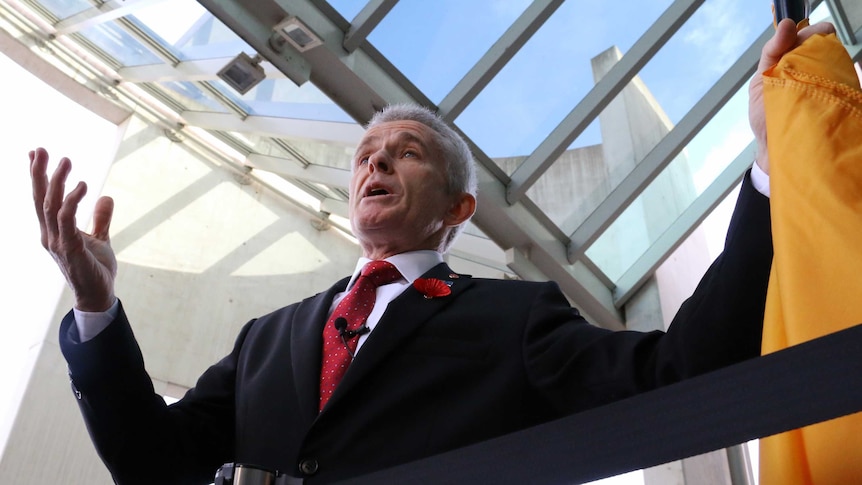 One Nation Senator Malcolm Roberts gestures outside Parliament House