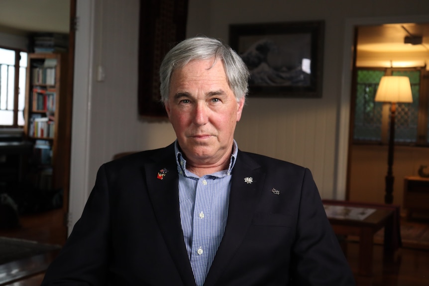 David Freeman looks into camera with a serious expression on his face.