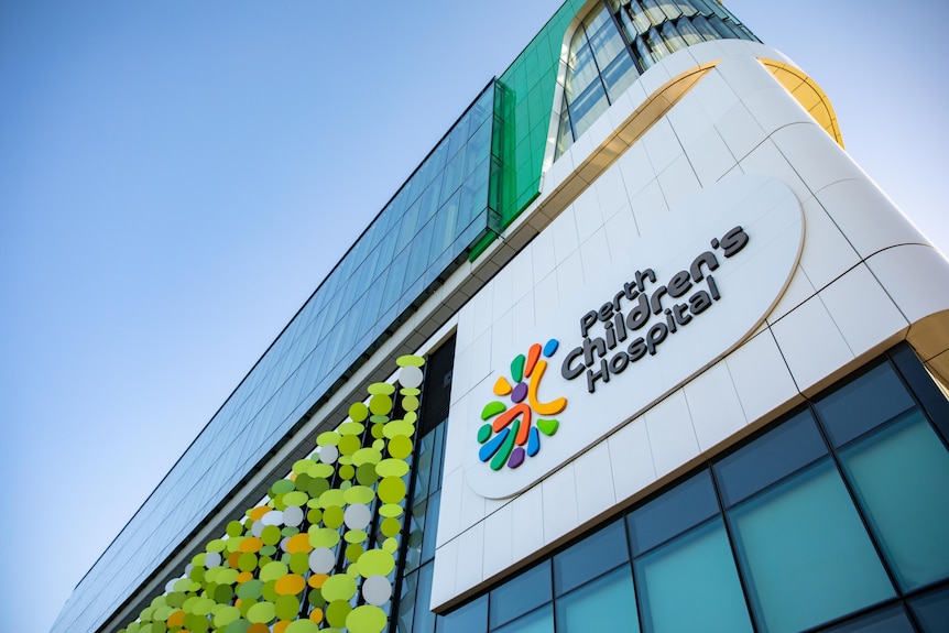 A low shot looking up at a sign on the side of Perth Children's Hospital.