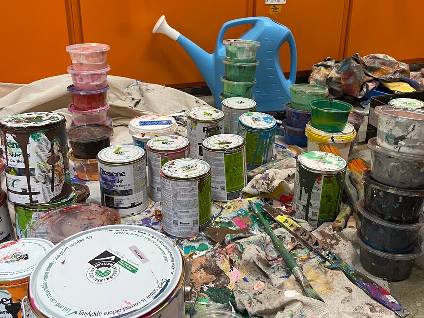 Multiple tins of paint. 