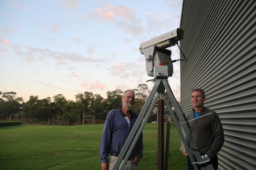 Richard Hamilton (left) and Murray Leake (right) with the laser they are using to scare birds.