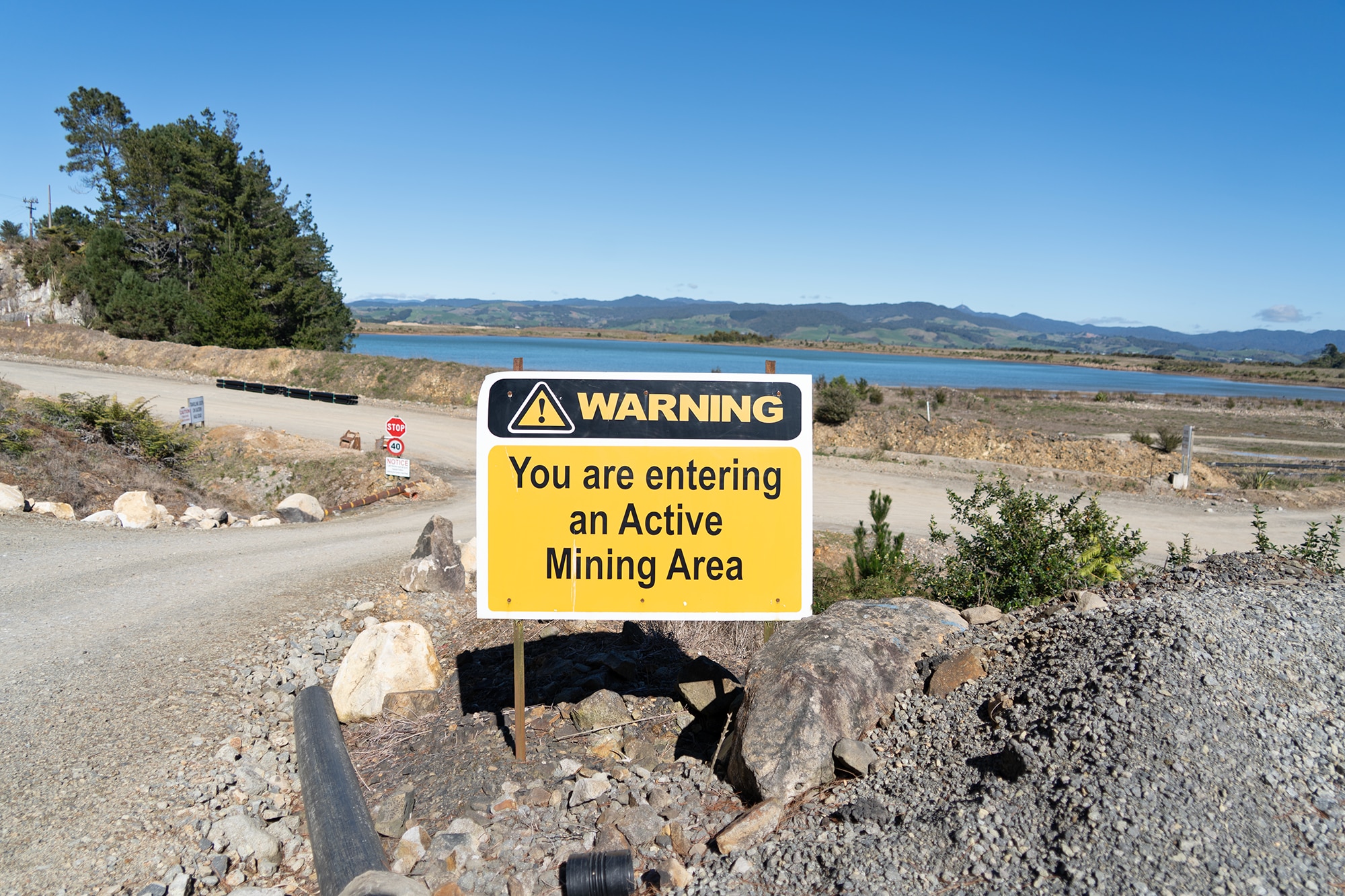 A warning sign at the entrance of the mining area.