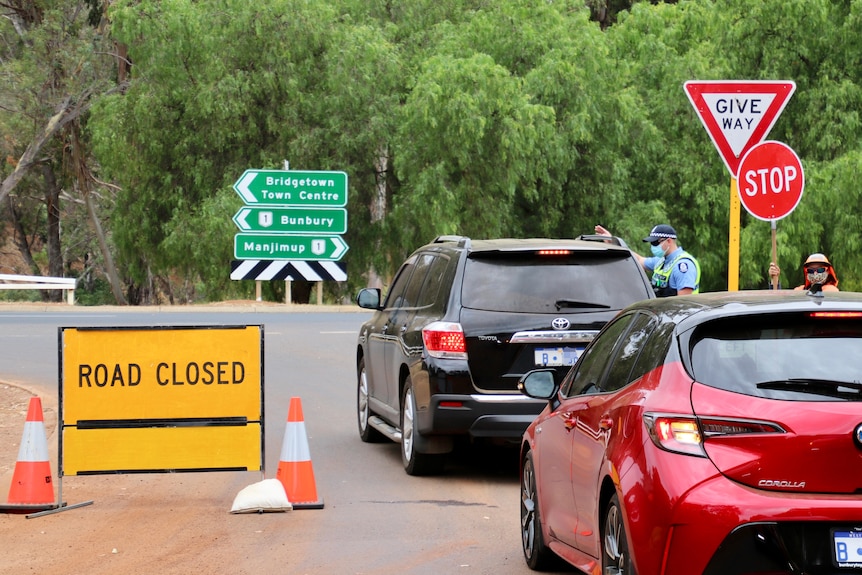 Cars at a police road block.