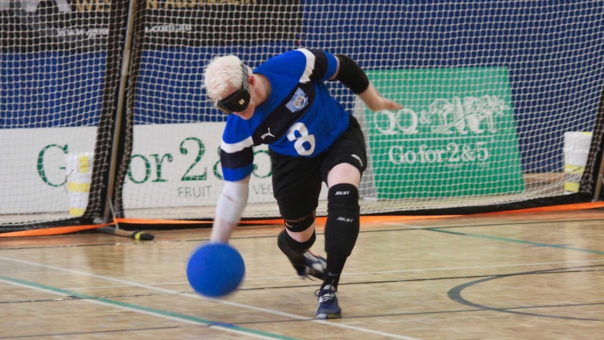 Goalball player throws ball down the court