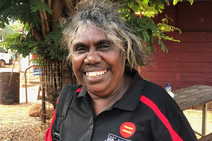 Matilda Oxtoby of the Kalumburu community standing in garden and smiling at camera