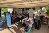 People sitting down waiting to be vaccinated at Goondiwindi