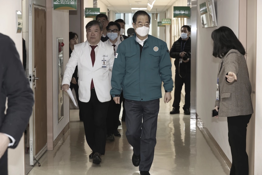 Men walking through a hospital 