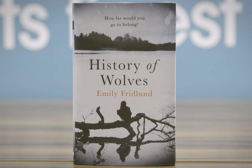 Colour photograph of the History of Wolves by Emily Fridlund book standing on a table top.