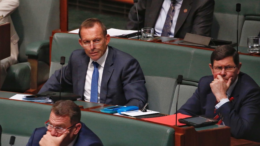 Former prime minister Tony Abbott sits next to Kevin Andrews
