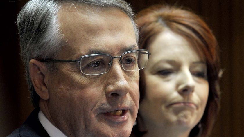 Prime Minister Julia Gillard, right, listens to Federal Treasure Wayne Swan