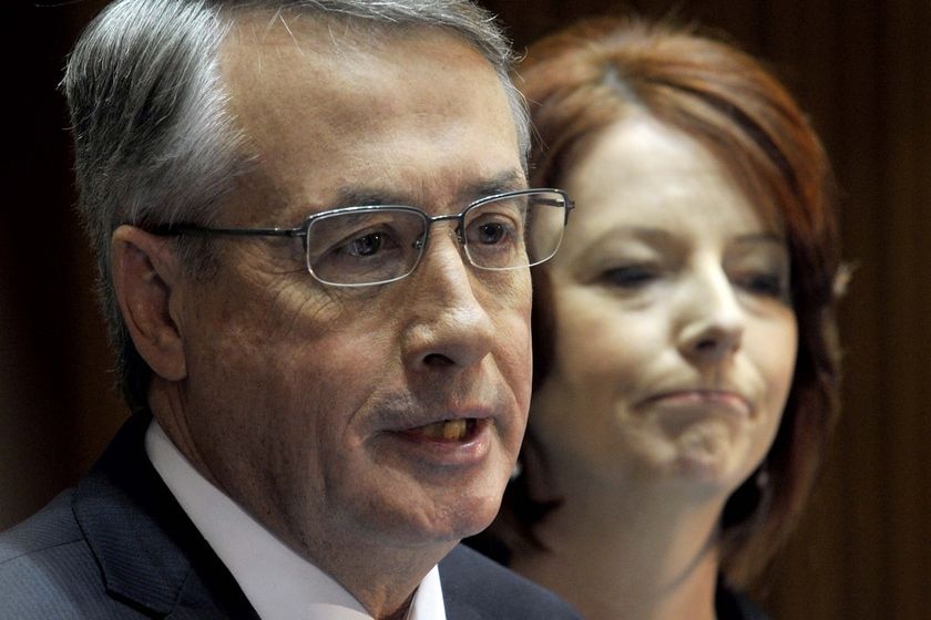 Prime Minister Julia Gillard, right, listens to Federal Treasure Wayne Swan