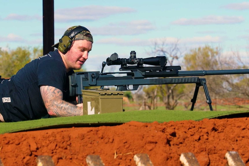 A man gets ready to shoot a firearm