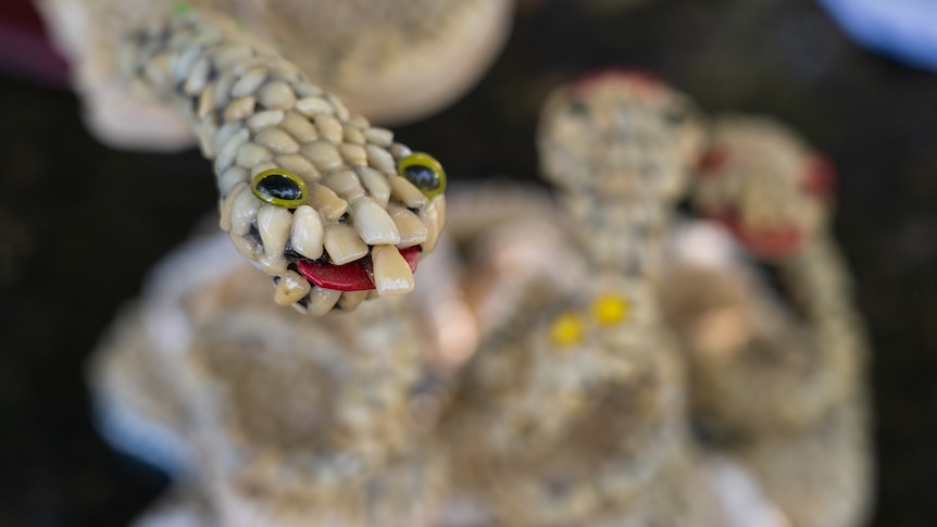 a sculpture of a snake made from human teeth.