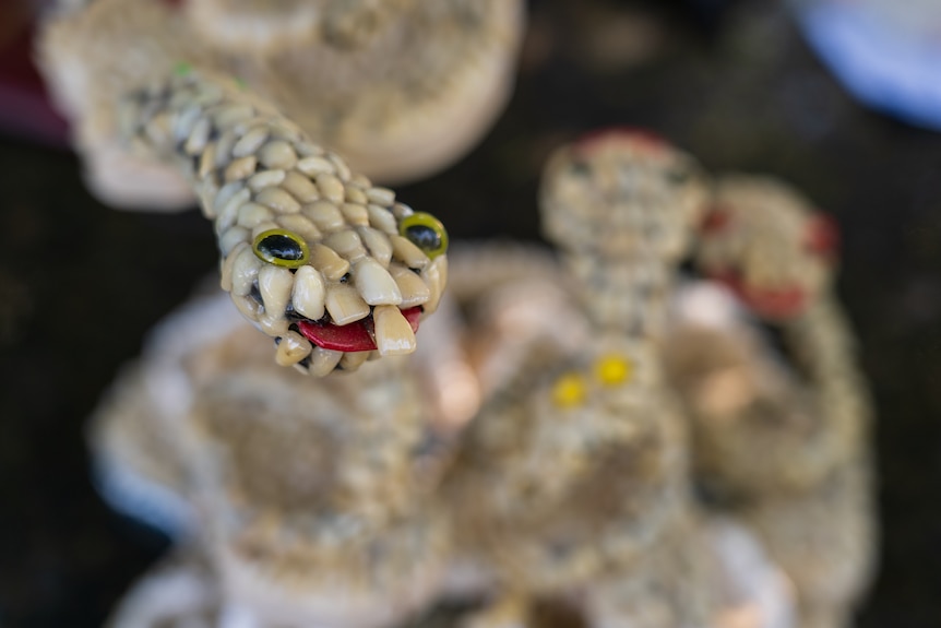 a sculpture of a snake made from human teeth.