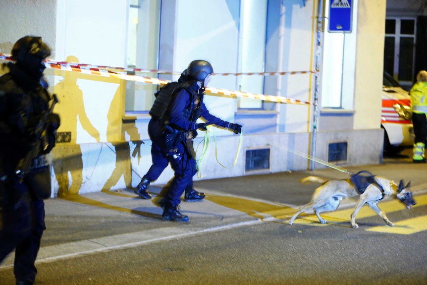 Police stand outside an Islamic centre in central Zurich, Switzerland