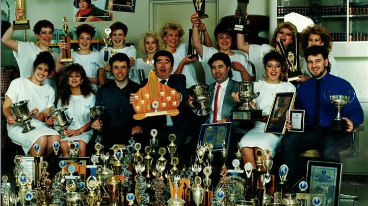 Cataldo’s Salon team with their competition trophies, circa 1980s. Front row 3rd from left: Emilio Cataldo, Giuseppe Cataldo, Angelo Cataldo, Anna Cataldo  Back row 5th from left: Karen Spradau (business partner and Director of Cataldo’s Salon Woden)