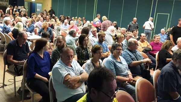 Residents meet to discuss a class against against Defence