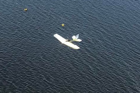 A plane sits in a large body of water
