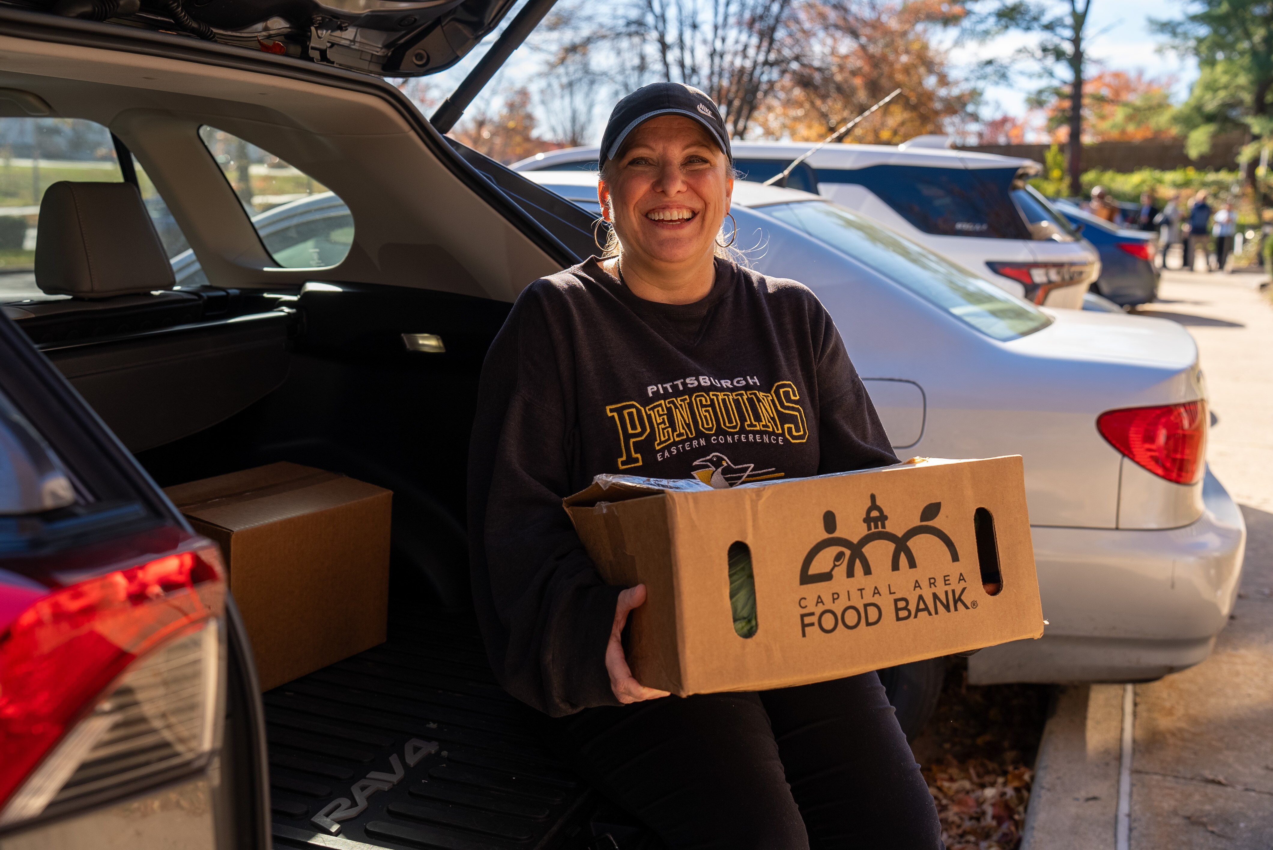 Amy Flanery holds a box of food items. 