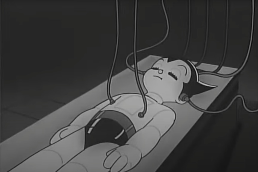 A black and white shot of Astro Boy lying down.