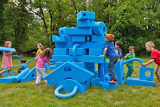 Children with the large components of a portable Adelaide playground.