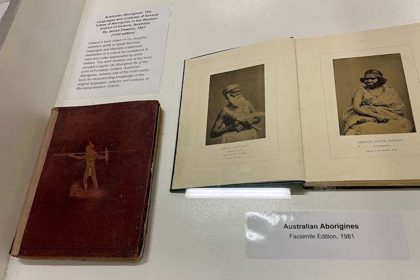 An old book from 1881, next to new version open to portraits of indigenous people