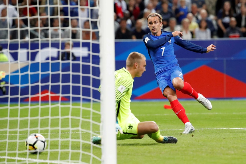 France's Antoine Griezmann scores against the Netherlands in Saint-Denis on August 31, 2017.