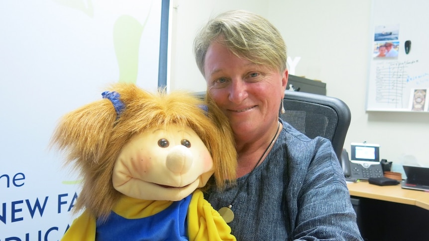 Professor Kerry Reid-Searl holds on of the puppets she uses to teach children about health issues