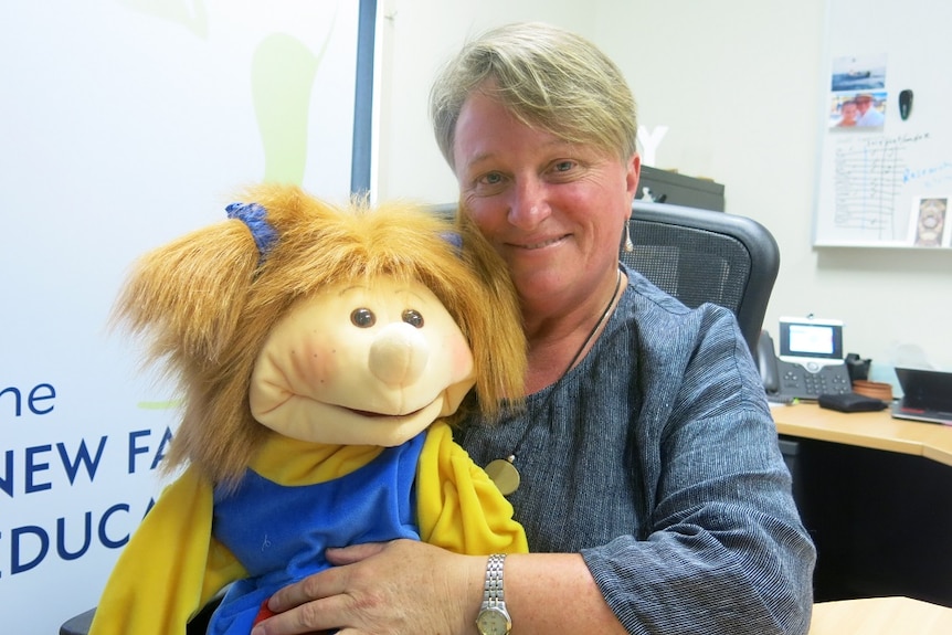 Professor Kerry Reid-Searl holds on of the puppets she uses to teach children about health issues