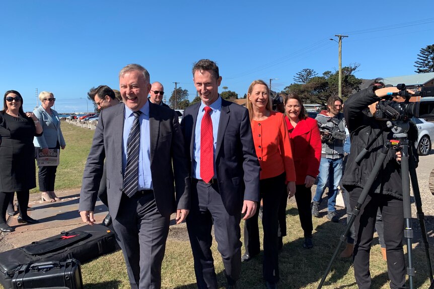 Group of people in suits walking, including federal labor leader Anthony Albanese and member for Cunningham Sharon Bird.